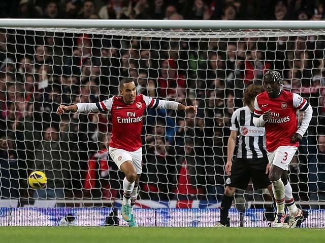 Theo Walcott celebrates after scoring his second against Newcastle on December 29, 2012