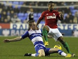 Swansea winger Wayne Routledge is tackled by Reading's Alex Pearce during the match on December 26, 2012