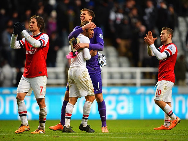 Arsenal players celebrate their win over Newcastle after the final whistle of their Premier League match on December 29, 2013