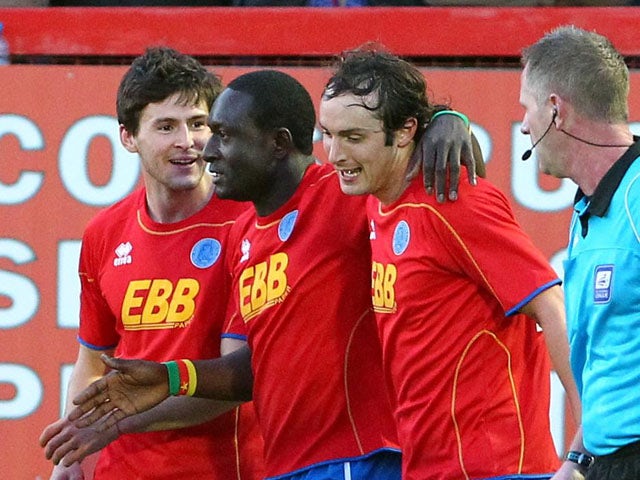 Aldershot's Guy Madjo (centre) celebrates with teammates after scoring during their match on April 17, 2012