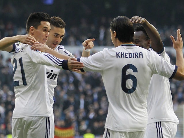 Real Madrid players congratulate Karim Benzema on an early goal against Real Sociedad on January 6, 2013