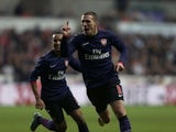 Lukas Podolski celebrates scoring Arsenal's first goal against Swansea on January 6, 2013