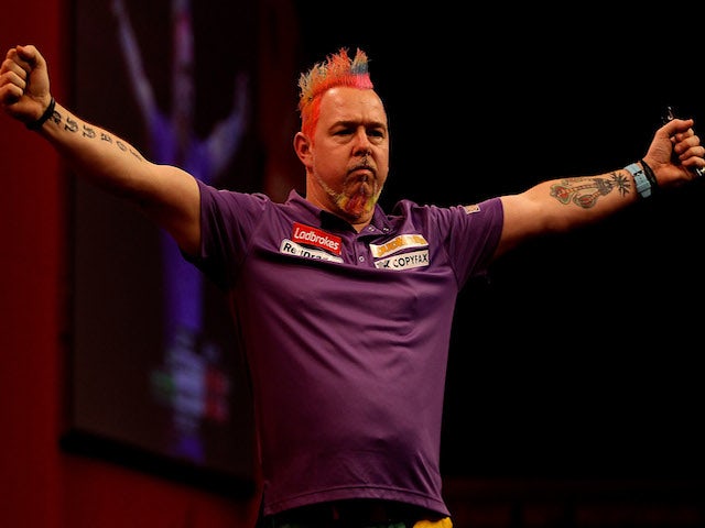 Peter Wright of Scotland celebrates defeating Simon Whitlock of Australia in their semi final match on day fifteen of the Ladbrokes.com World Darts Championship on December 30, 2013