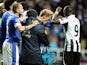 Players from both sides check on Phil Neville after he cut his head during the game between Everton and Newcastle on January 2, 2013
