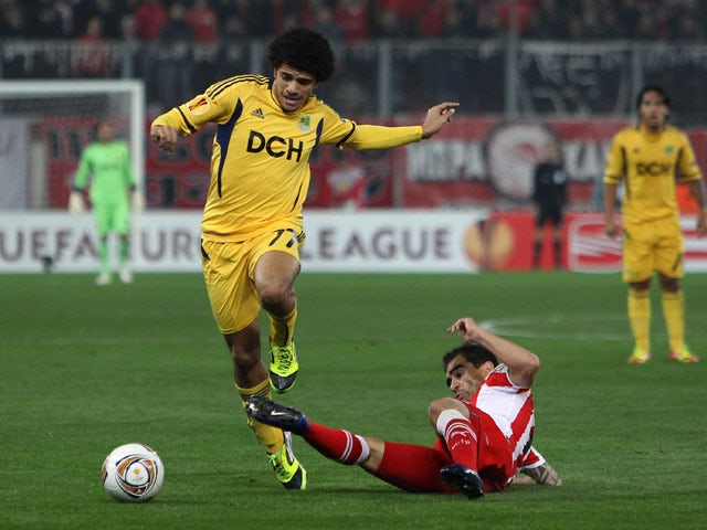 Taison of Metalist Kharkiv is challenged during their Europa League second leg tie on March 15, 2012