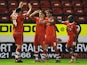 Walsall's Will Grigg celebrates with team mates after scoring his team's second goal against Portsmouth on January 4, 2013