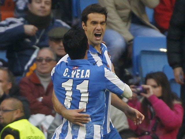 Real Sociedad's Xabi Prieto is congratulated by Carlos Vela following his penalty against Real Madrid on January 6, 2013