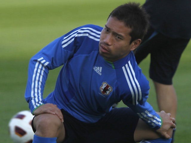 Japan's Yuto Nagamoto stretches during a training session in Qatar on January 6, 2011