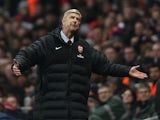Arsenal boss Arsene Wenger stands dejected after the sending off of Laurent Koscielny against Man City on January 13, 2013