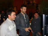 Gerard Pique and Lionel Messi playing FIFA
