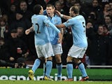 City midfielder James Milner celebrates with teammates after his goal against Arsenal on January 13, 2013