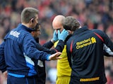 Liverpool goalkeeper Pepe Reina receives treatment after a clash with Manchester United's Shinji Kagawa on January 13, 2013