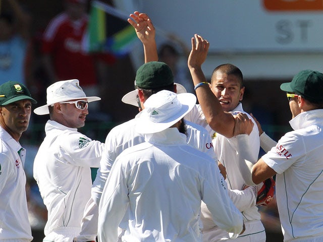 South Africa players celebrate with bowler Rory Kleinveldt during their match with New Zealand on 13 January, 2013