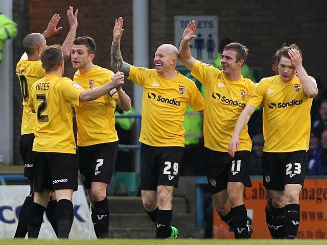 Port Vales's Tom Pope is congratulated by team mates after scoring the opener against Gillingham on January 12, 2013