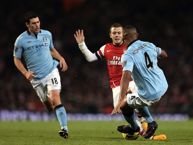 City captain Vincent Kompany tackles Arsenal's Jack Wilshere, a challenge which saw him receive a red card on January 13, 2013