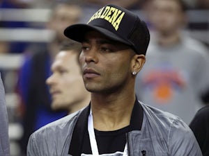 Chelsea soccer player Ashley Cole watches the New York Knicks and Detroit Pistons NBA basketball game at the 02 arena on January 17, 2013
