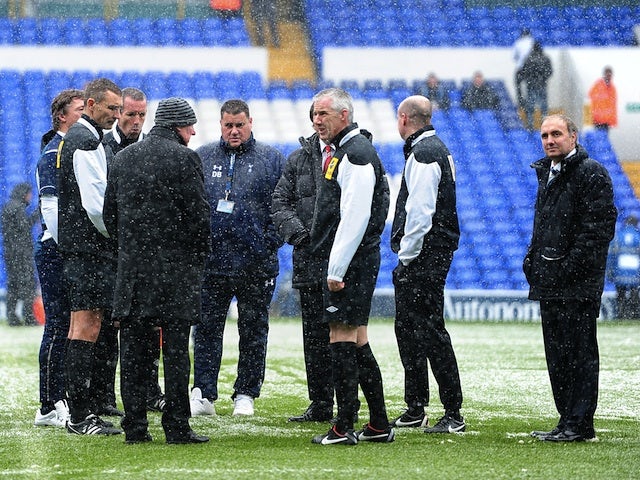Referee Chris Foy inspects the pitch before kick-off between Tottenham and Man Utd on January 20, 2013