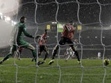 Spurs' Clint Dempsey slides home a late equaliser against Man Utd on January 20, 2013