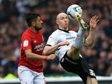 Derby's Conor Sammon and Forest's Gonzalo Jara battle for the ball on January 19, 2013