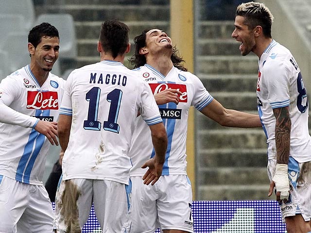 Napoli's Edinson Cavani is congratulated by team mates after heading in the equaliser against Fiorentina on January 20, 2013