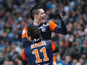 Montpellier's Emanuel Herrera is congratulated by Remy Cabella after a goal against Marseille on January 19, 2013