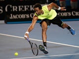 Gael Monfils reaches out for a backhand return to Gilles Simon during their third round match at the Australian Open on January 19, 2013