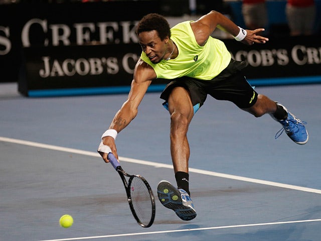 Gael Monfils reaches out for a backhand return to Gilles Simon during their third round match at the Australian Open on January 19, 2013