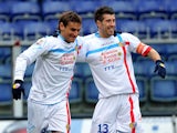 Catania's Gonzalo Bergessio is congratulated by team mate Mariano Julio Izco after scoring the opening goal against Genoa on January 20, 2013
