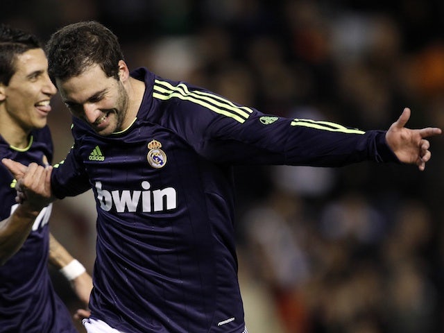 Real striker Gonzalo Higuain celebrates his goal against Valencia on January 20, 2013