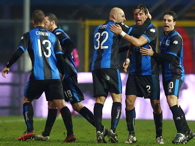 Atalanta's Guglielmo Stendardo is congratulated by team mates after scoring the equaliser against Cagliari on January 20, 2013