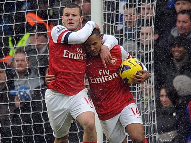 Jack Wilshere congratulates Theo Walcott after scoring against Chelsea on January 20, 2013