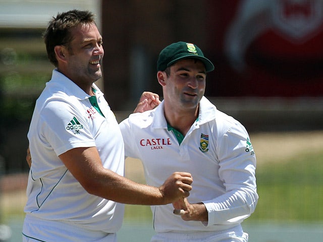 South Africa's Dean Elgar congratulates his team mates Jacques Kallis after dismissing New Zealand's Dean Brownlie on January 14, 2013
