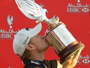 Welshman Jamie Donaldson kisses the trophy after winning the Abu Dhabi Golf Championship on January 20, 2013