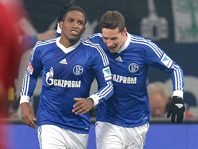 Schalke's Jefferson Farfan is congratulated by team mate Julian Draxler after scoring the opening goal against Hannover on January 18, 2013