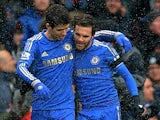 Juan Mata celebrates with team mate Emboaba Oscar after scoring the opening goal against Arsenal on January 20, 2013