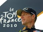 Lance Armstrong in front of a Tour de France brand board in 2010