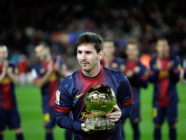 Lionel Messi poses with his FIFA Men's World Player of the Year award before the Copa del Rey match against Malaga on January 16, 2013