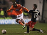 Blackpool's Ludovic Sylvestre battles Cardiff's Aaron Gunnarsson for possession on January 19, 2013