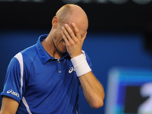 Nikolay Davydenko reacts during his defeat to Roger Federer at the Australian Open on January 17, 2013