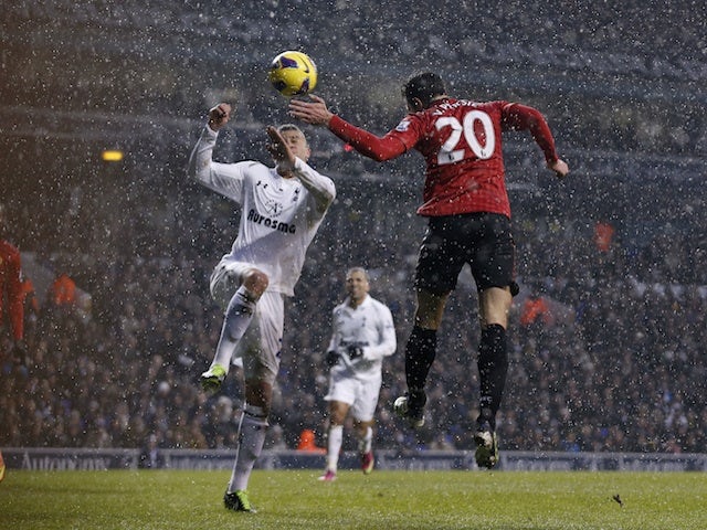 United forward RVP heads home the first goal against Tottenham on January 20, 2013
