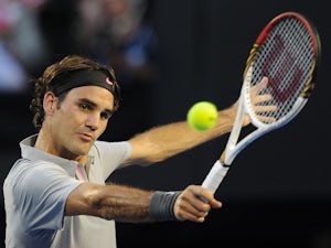 Federer brushes Tomic aside