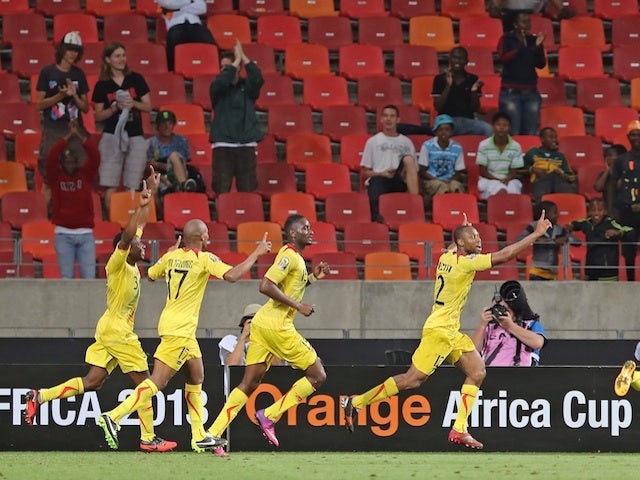 Mali skipper Seydou Keita celebrates his goal as teammates follow, after a strike against Niger on January 20, 2013