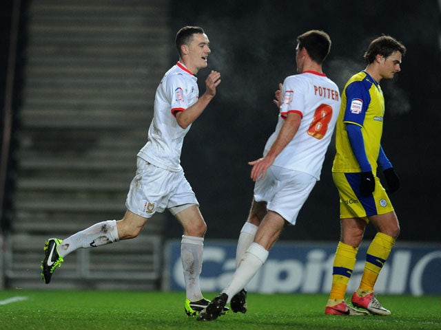 Shaun Williams celebrates scoring for MK Dons in their FA Cup third round replay on January 15, 2013