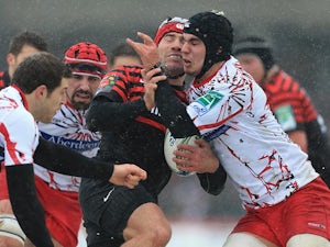 Saracens' Schalk Brits is stopped by Edinburgh's Stuart McInally during their Heineken Cup match on January 20, 2013