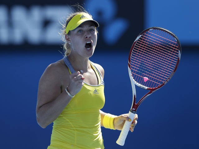 German Angelique Kerber celebrates after winning her first round match against Elina Svitolina at the Australian Open tennis championship on January 14, 2013