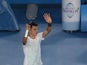Bernard Tomic from Australia waves to the crowd after defeating Leonardo Mayer in the first round at the Australian Open tennis championship on January 15, 2013