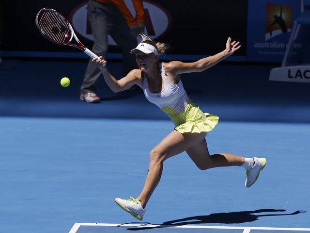 Caroline Wozniacki hits a forehand return in her first round match at the Australian Open tennis championship on January 15, 2013