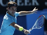 Roger Federer makes a backhand return in his first round match against Benoit Paire at the Australian Open tennis championship on January 15, 2013