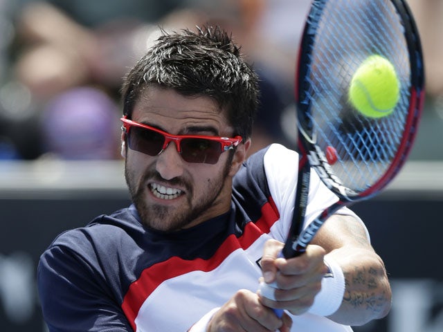 Serbia's Janko Tipsarevic plays a shot in his third round match against Julien Benneteau at the Australian Open tennis championship on January 18, 2013