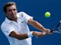 Julien Benneteau of France returns a shot during his first round match with Grigor Dimitrov in the Australian Open tennis championship on January 14, 2013